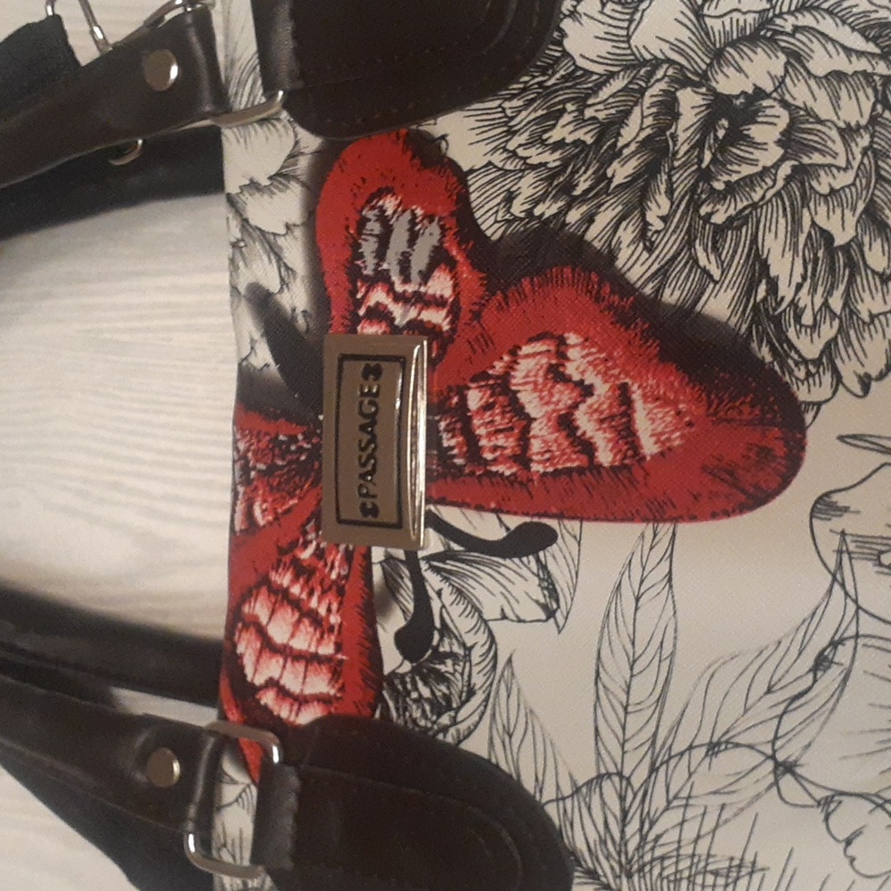 Butterfly print travel bag with shoulder strap included.